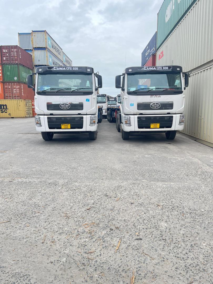 Two truck-tractors parked nose-to-nose in the yard